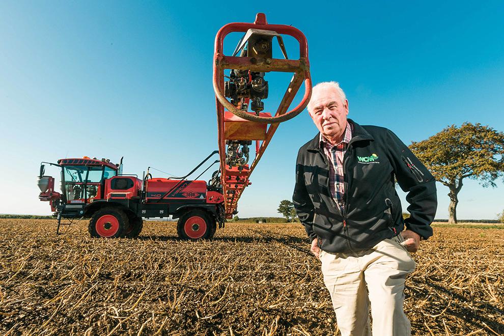 Photograph of Robert Kendal on farm next to a sprayer with 3d ninety nozzles